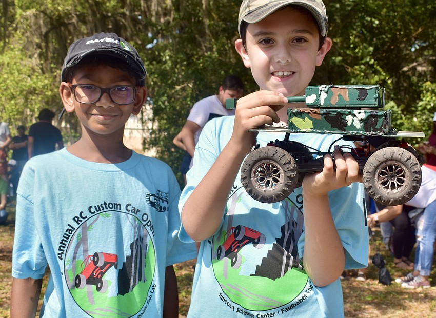 Shri Raj and teammate Brendan Jaikaran show off their winning car after the final race.