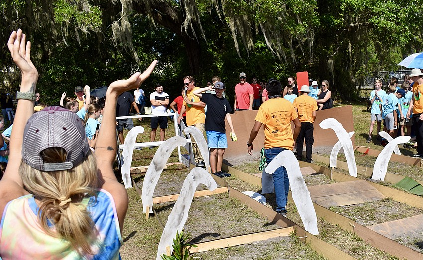 A crowd gathers around the elementary and middle-school track.