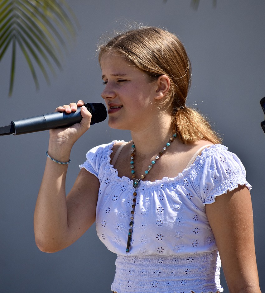 Aimee Mongiovi, 11, sings for the event. She is a student at Music Compound.