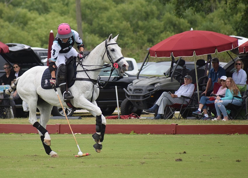 While Ocala's Alyson Poor controls the ball on her white horse, tailgaters enjoy the easy life along the sideline.