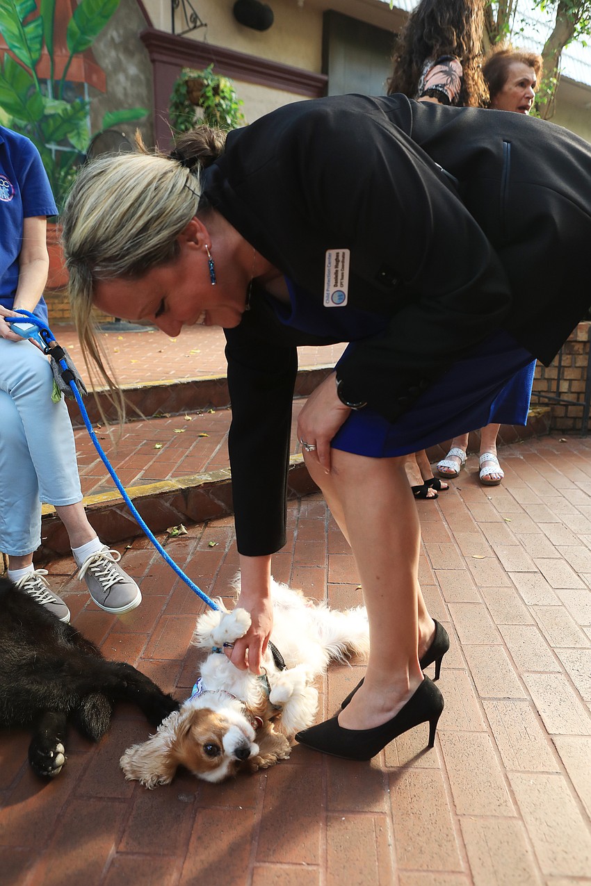 Danielle Hughes pets a support dog.