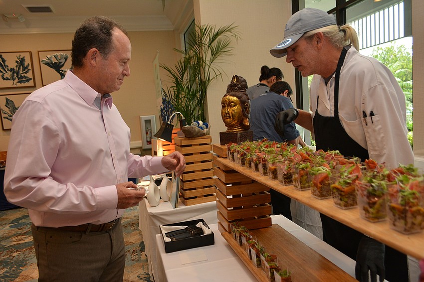 Tom Pluss peruses the tun and quinoa bowls from Bill Smith with the Longboat Key Club.