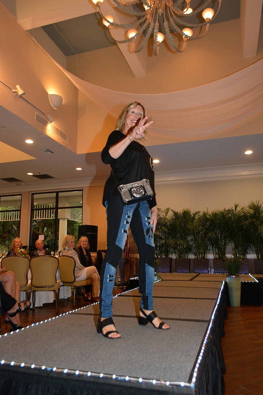 Diane Blake kicks off the fashion sow with a peace sign.