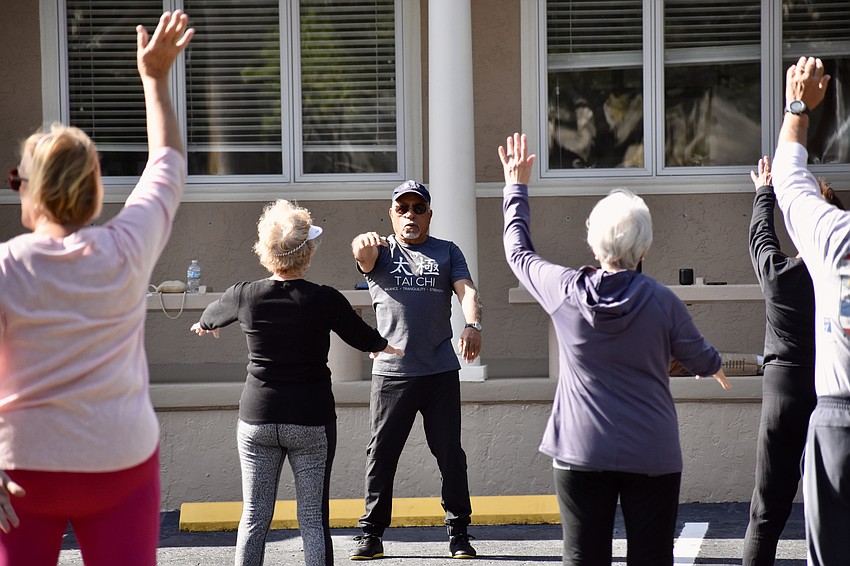 Certified tai chi instructor Reuben D. Fernandez warms up the group.