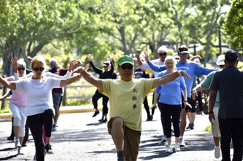 Master Max Yan  and certified instructor Reuben D. Fernandez led the class participants through a series of motion forms that took them around The Paradise Center parking lot.