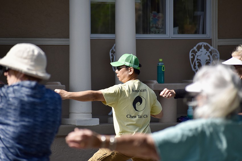 The assembled students follow the lead of Master Max Yan.