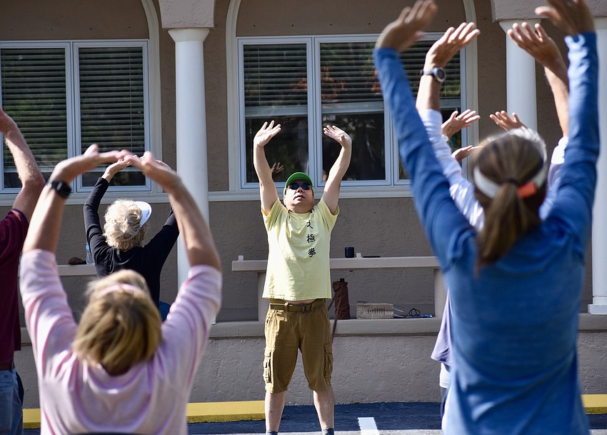 The assembled students follow the lead of Master Max Yan.