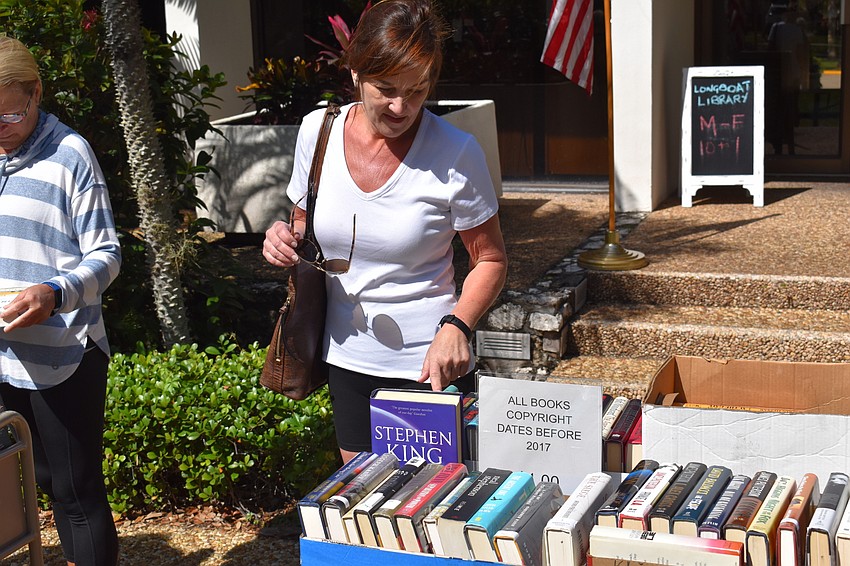 Gail Branham looks through the selection of books for sale.