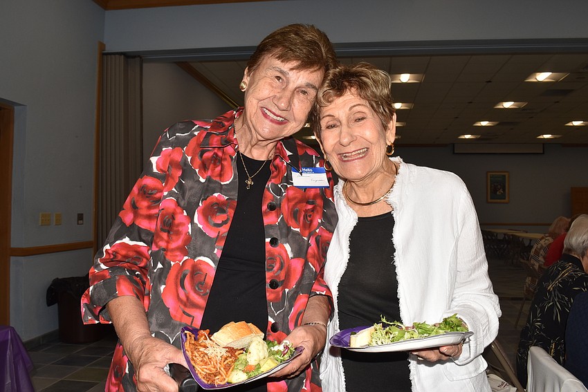 Dolores Engelke and Jane Vorel head back with their food.