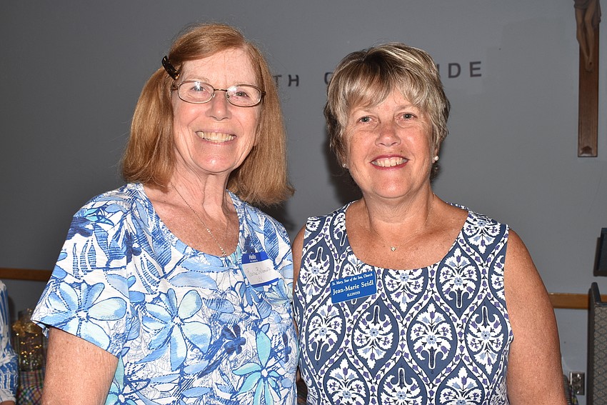 Barbara Bellamente and Jean-Marie Seidl wait in line for lunch.