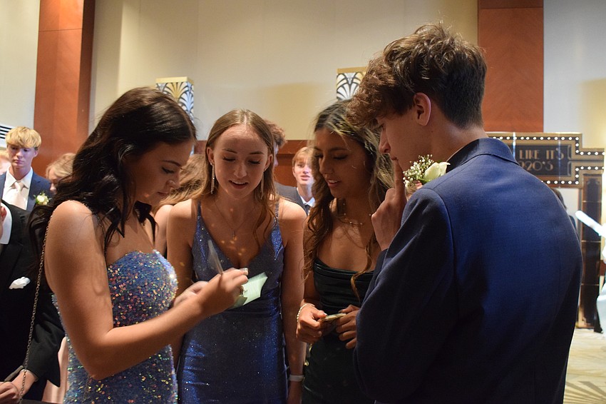 Seniors Taylor Liffey, Emma Hurrle, Gabby Colacci and Bryson Demott discuss whom they plan to vote for as prom king and queen.