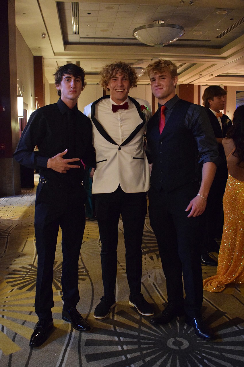 Seniors Landon Antritt and Tobin Santilli and junior Riley Scofield head to the dance floor.