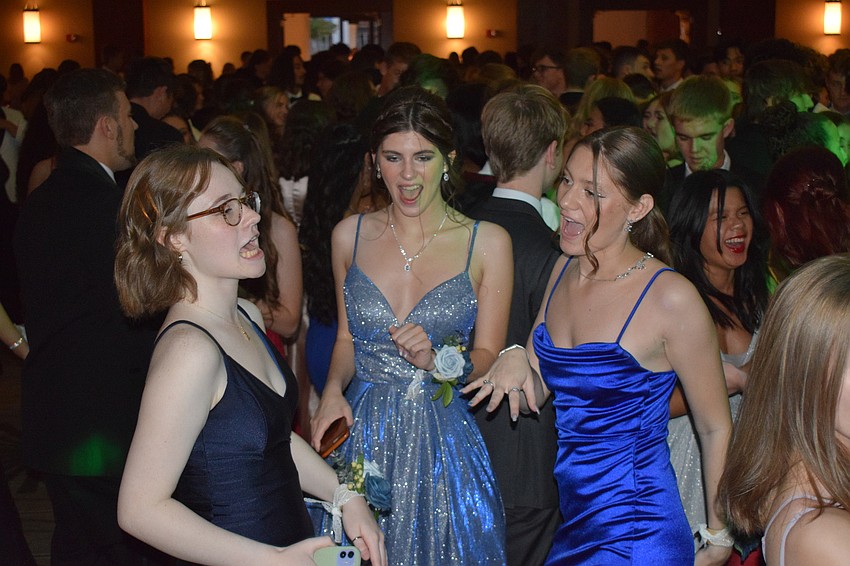 Seniors Sara Mills, Ella Hansen and Lani Fisher sing along to the music while dancing.