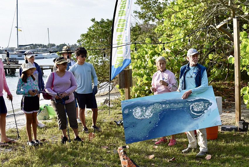 Ronda Ryan, president of Sarasota Bay Watch, and Rusty Chinnis talk about Sister Keys and where the volunteers would be working.