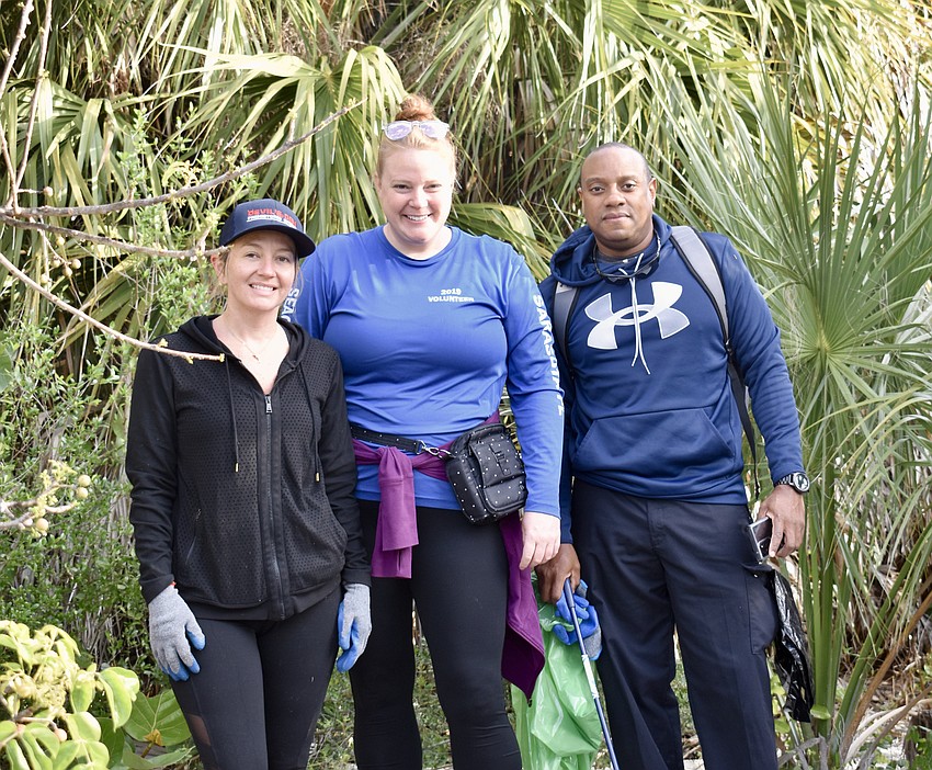 Cody Jeffers, Catherine Deveux and Hugh Brian get to work cleaning up the island.