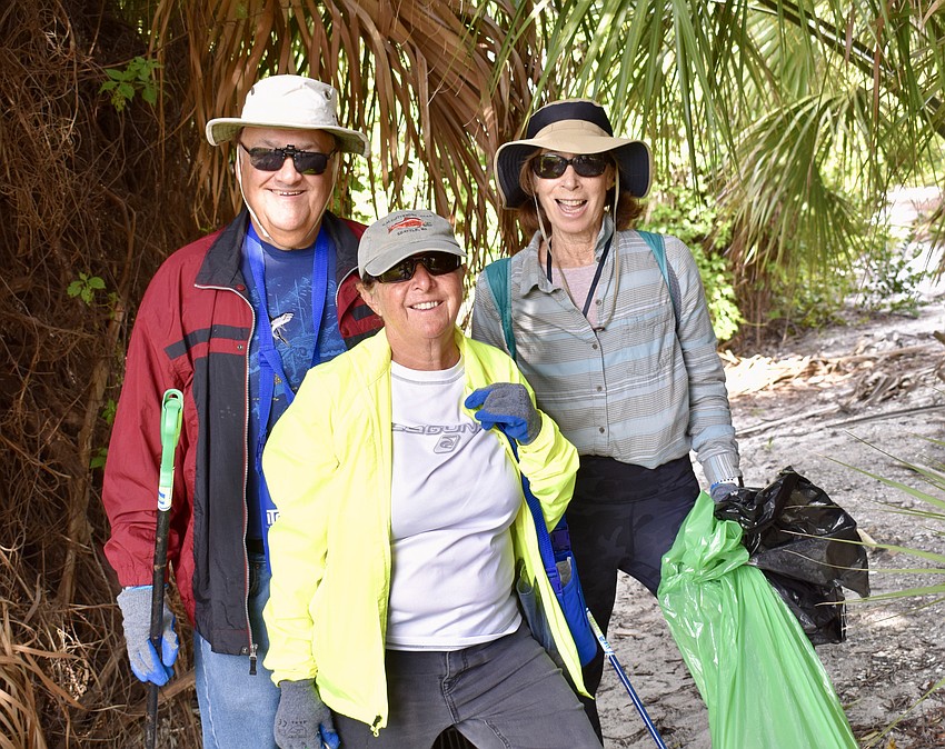 Gene Printz-Kopelson, Mindy Printz-Kopelson, and Audrey Bear take a moment during their clean-up work on the island.