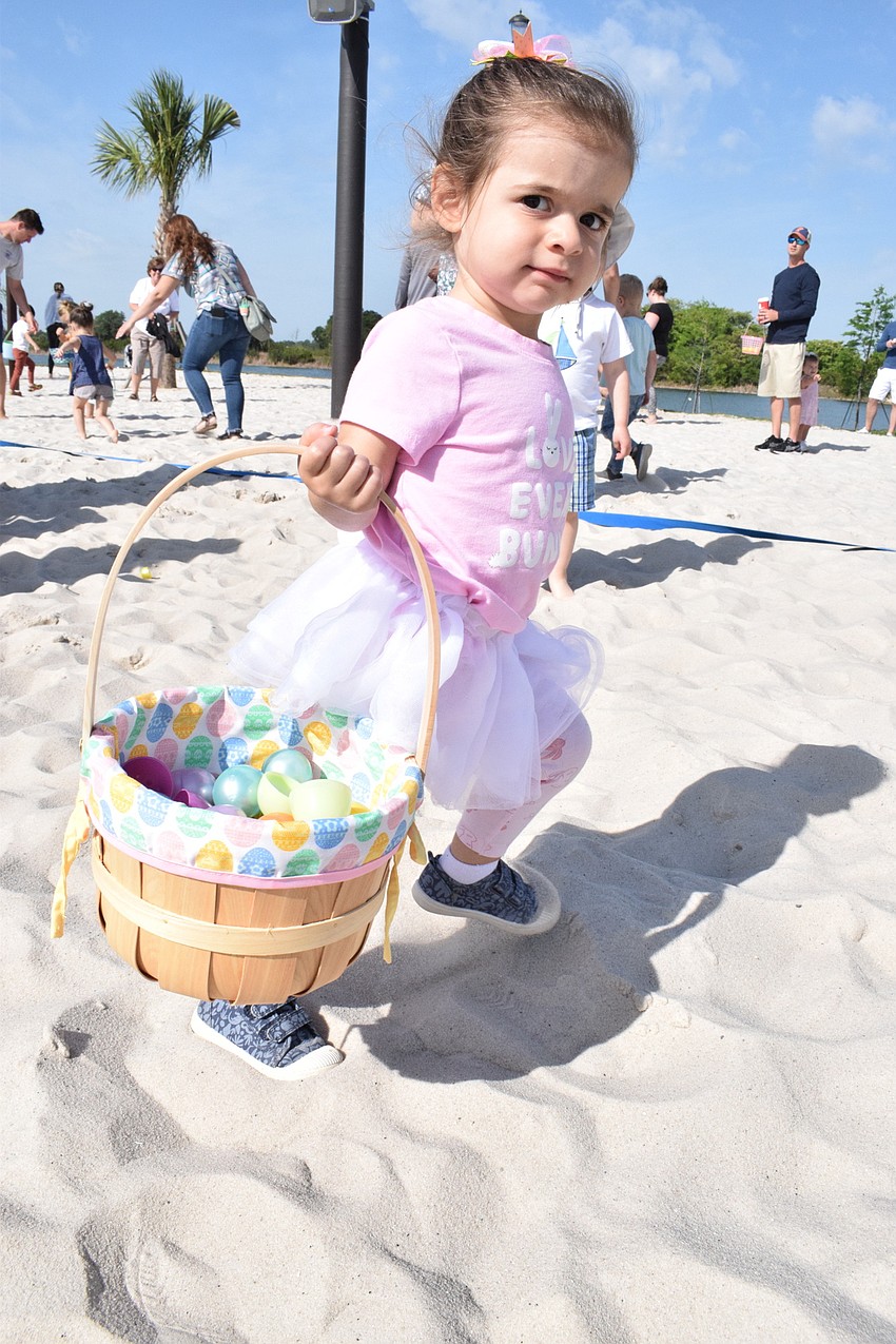 Lakewood Ranch's Brooklyn Hendrickson runs around the volleyball courts collecting eggs.