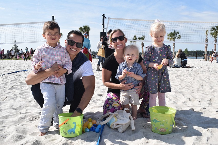 Sarasota's Isaac Guerrero, who is 3, goes through the eggs he collected with his dad Xavier Guerrero and Sarasota's Kat Boerner and 18-months-old Pax Boerner and 3-year-old Sunny Boerner.
