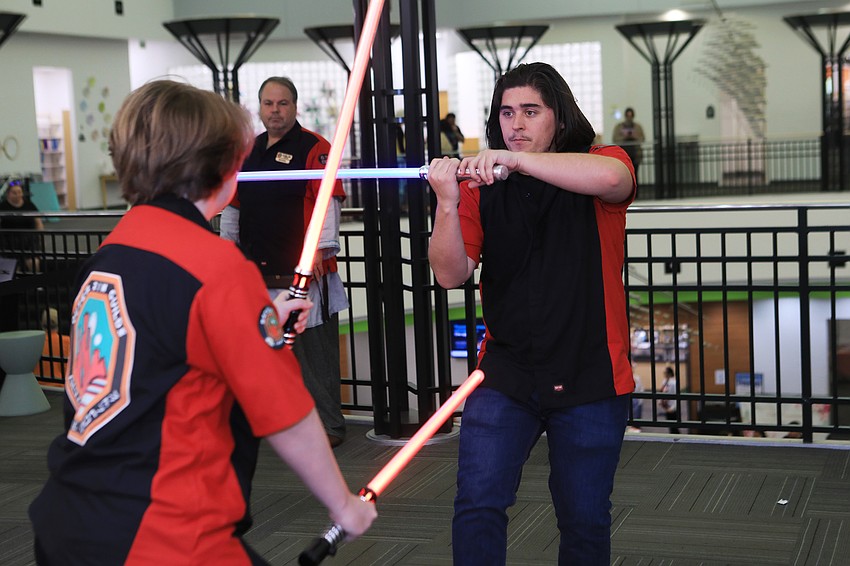 Peri Adamides spars with Eddy Cooper at the Outer Rim Guilds lightsaber show.