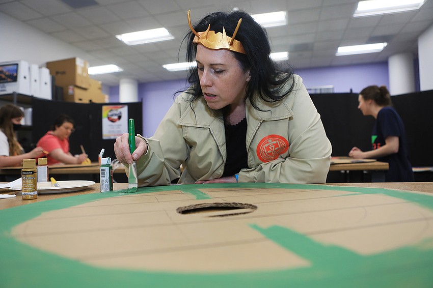 Nienna Nir paints a viking shield.