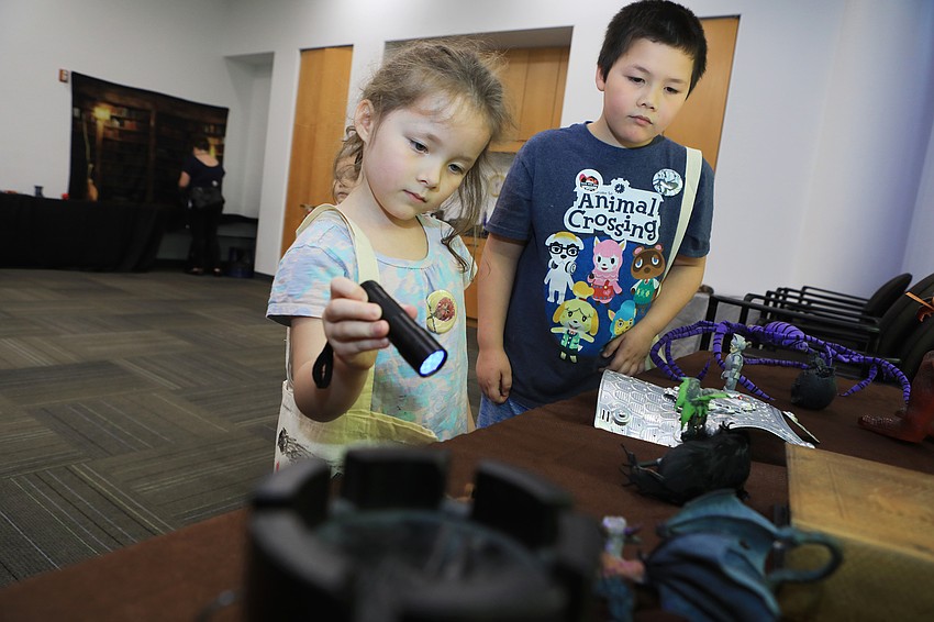Freya and Jin Chen search for clues in the escape room.