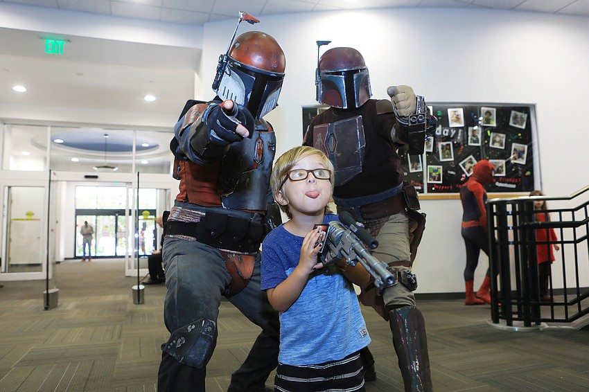 Benjamin Bricker poses with some Star Wars characters.