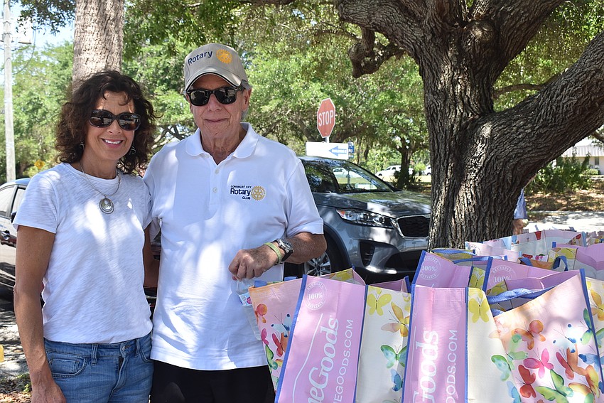 Betsy Nordstrom and Gene Luca prepare to give out bags.
