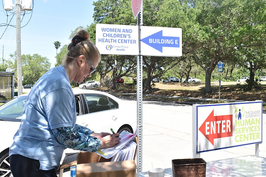 Kristin Poolman sorts through envelopes containing recipes and gift cards.