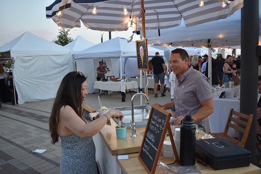 Lakewood Ranch's Sylvia McGinn buys a treat from Braden Wood's Ryan Edwards, who owns Great Heights Creamery.