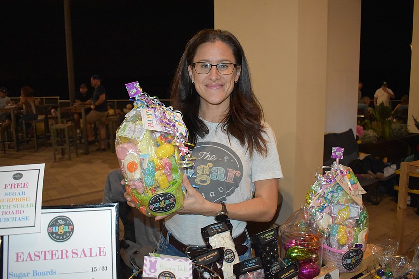 Dee Spiliopoulos, the owner of The Sugar Board, sells Easter baskets at the marketplace.