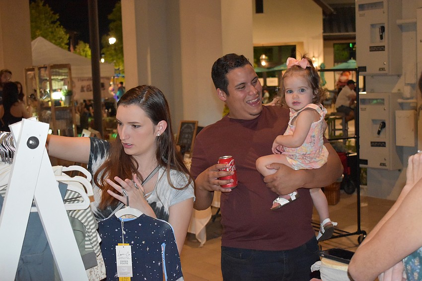 Lakewood Ranch's Hannah and Jonathan Garcias browse the marketplace with their daughter Mila Garcias.