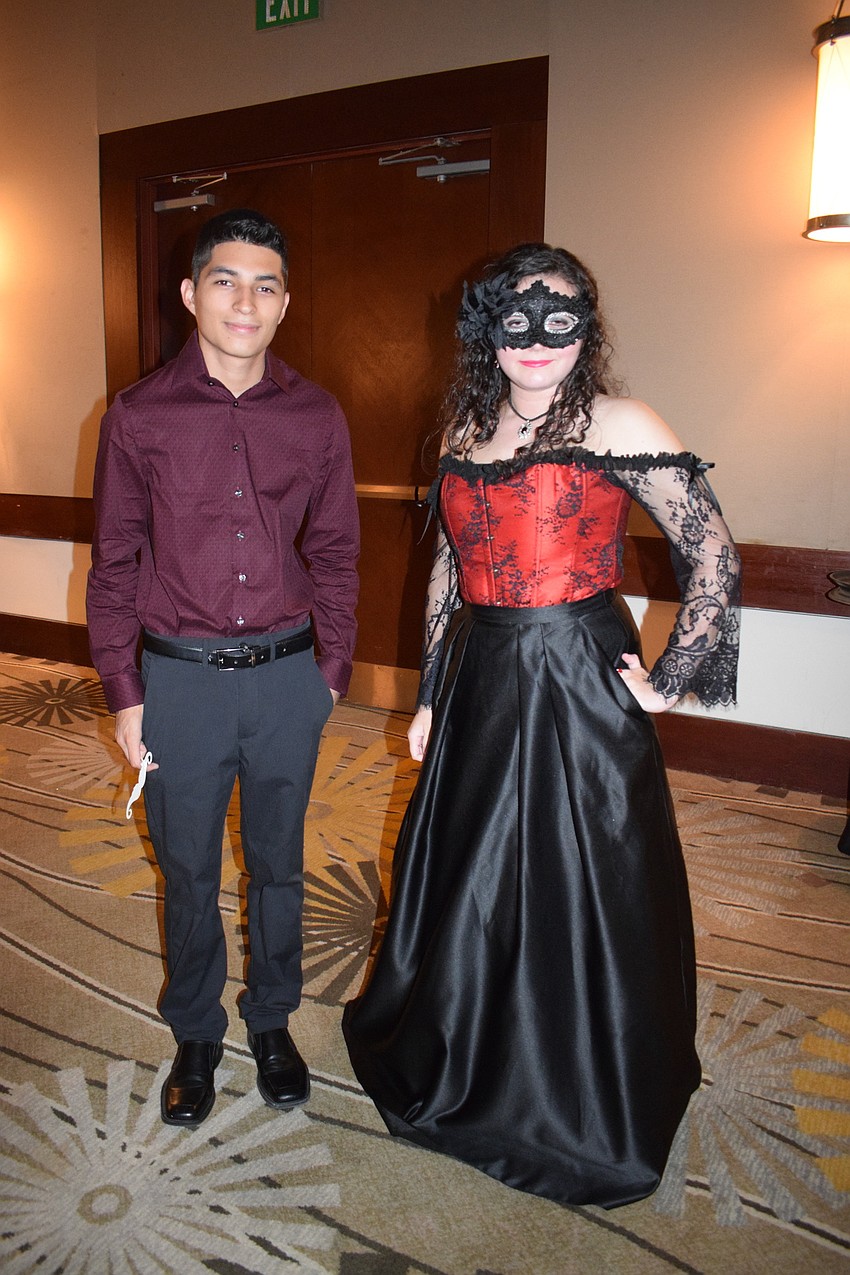 Sophomore Mario Cruz and junior Kaitlyn Perez go all out with the masquerade theme. 