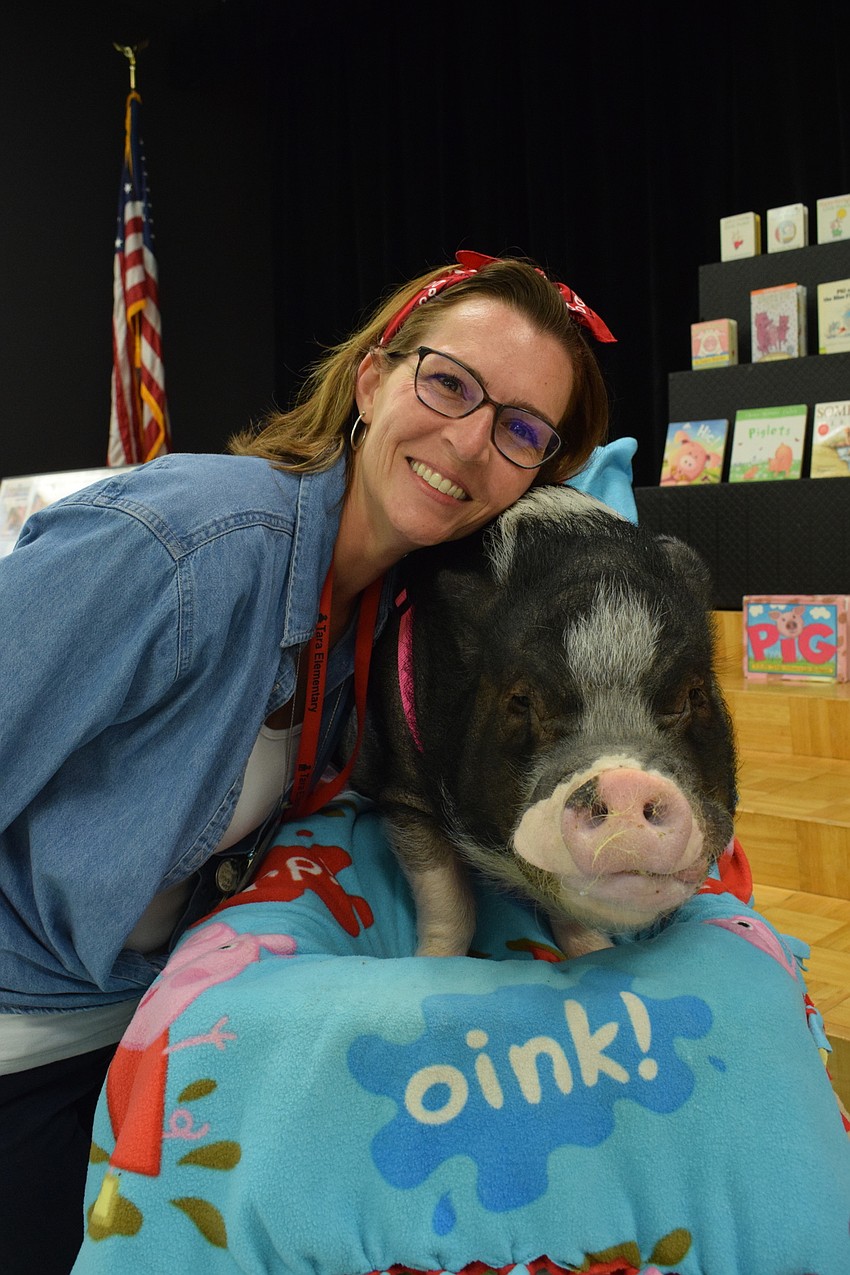 Laura Campbell, the principal, meets Daisy, a pig.