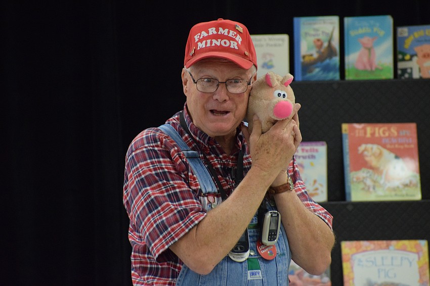 Paul Minor shows how small his pig Daisy was when she was a baby.