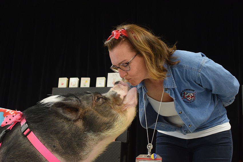 Daisy kisses Laura Campbell, the principal of Tara Elementary School.