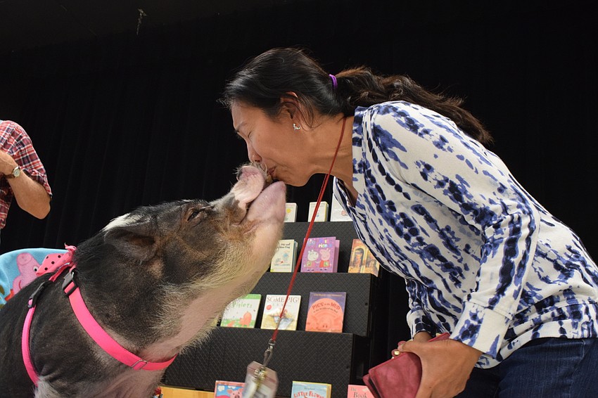 Daisy kisses Josephine Johnson, a kindergarten teacher.