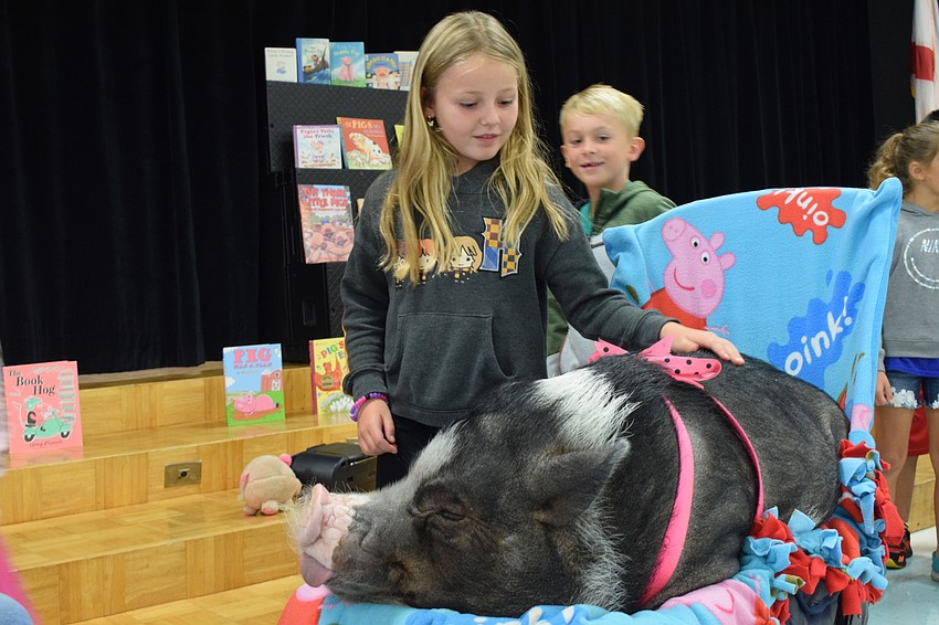 First grader Olivia Krumpf pets Daisy.