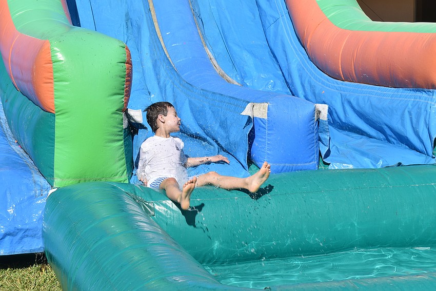 Mike Lepczyk slides down the inflatable water slide.