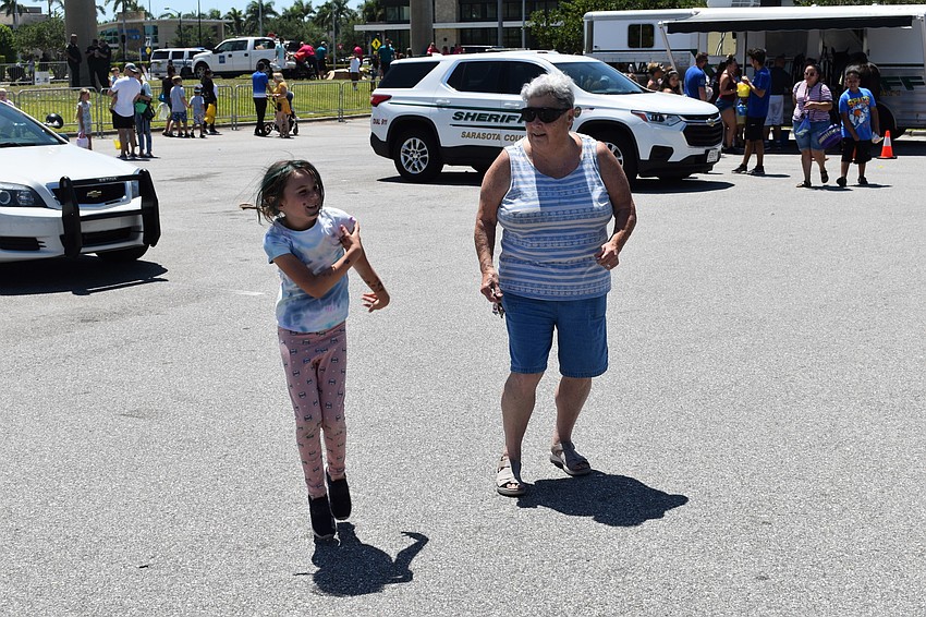 Bradenton's Lydia Heap, who is 7, and her grandmother Gail Catalan dance to songs from Disney's 