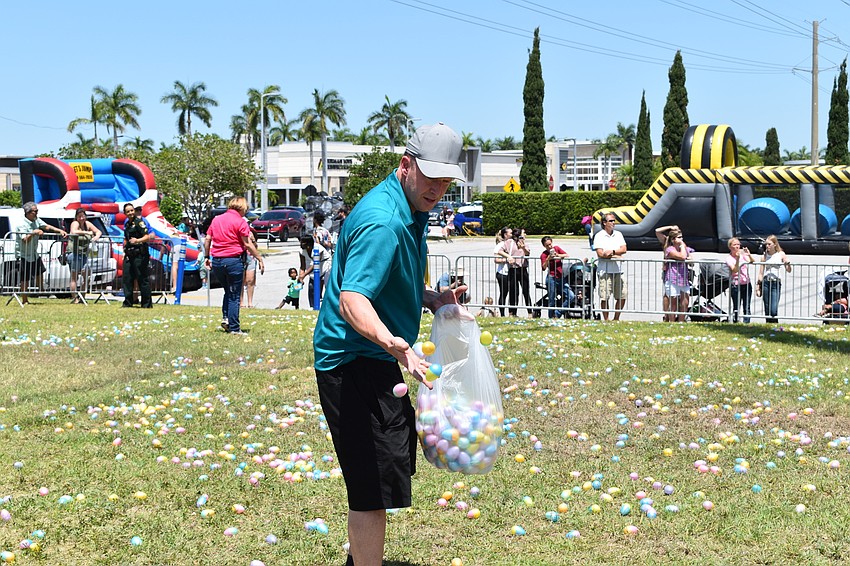 Bradenton's Felix Ascolese helps spread Easter eggs across the grass for the upcoming egg hunt.