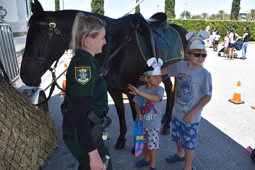 Sarasota County mounted patrol officer Jessica Yoder introduces her horse to Sarasota's Logan Siiman, who is 5, and Dylan Siiman, who is 8.