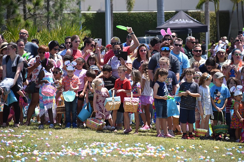 Families wait at the starting line in the field, well in advance of the egg hunts.