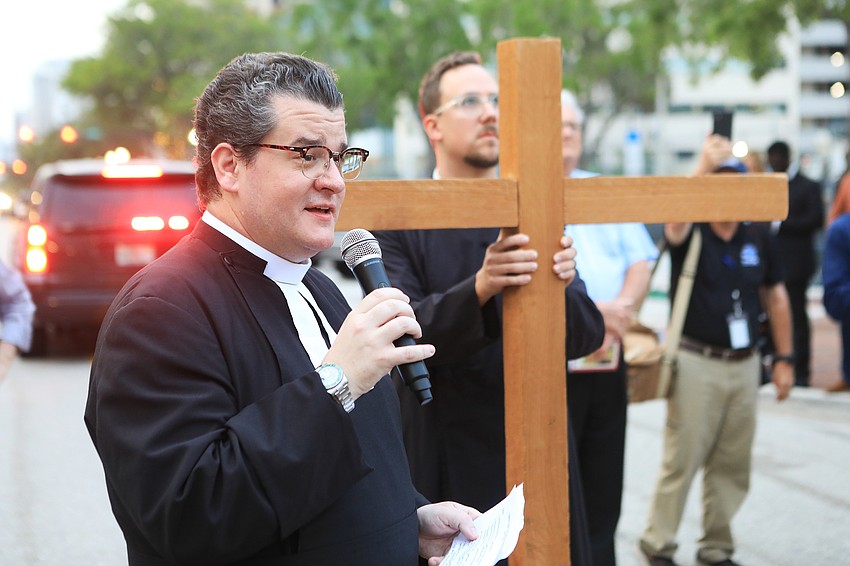 Father Charleston Wilson thanks the assembled crowd for joining in on the walk.