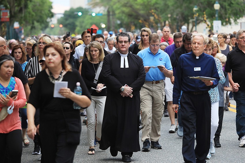 Father Charleston Wilson walks with the crowd.