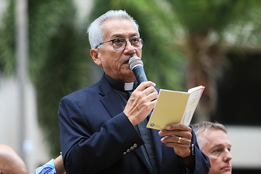 Deacon Humberto Alvia speaks to the crowd.