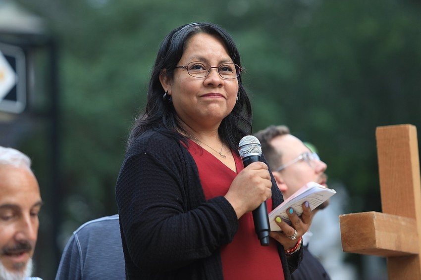 Marta Asencio speaks at a station.