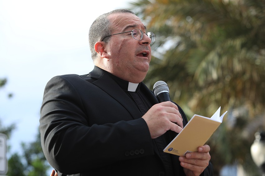 Father Gordon Zanetti speaks to the crowd.