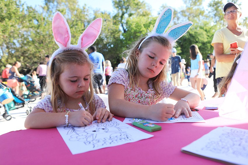 Emma and Ava Fischer cool off at the coloring station.