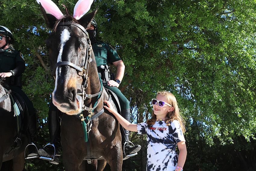 Anna Van Hellemont pets a horse.