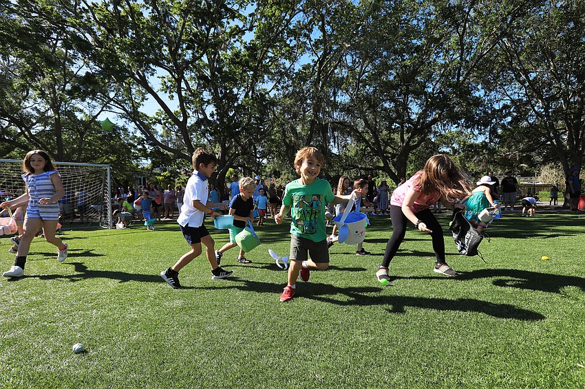 Dozens of children sprint during the egg hunt